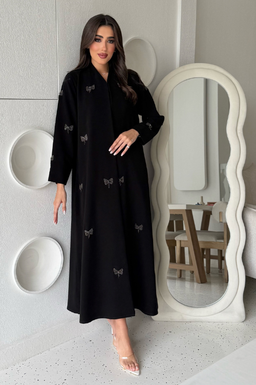 Sehrena Abaya featuring ribbon accents and intricate beadwork details.