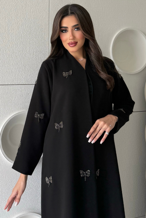 Sehrena Abaya featuring ribbon accents and intricate beadwork details.